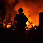 Soldier in front fire in Ukraine-Russia conflict.