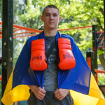 Vladyslav Rudenko with a Ukrainian flag and boxing gloves