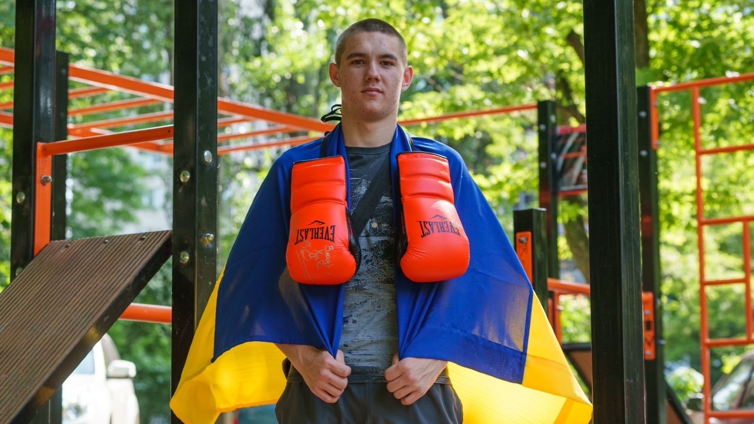 Vladyslav Rudenko with a Ukrainian flag and boxing gloves