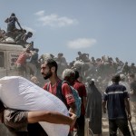 Palestinians struggling with severe food shortages amid ongoing Israeli attacks gather to receive limited aid supplies in northwestern Gaza.